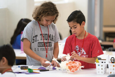 Campers glue together plastic straws